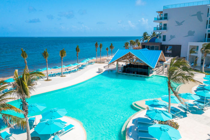 A pool area overlooking the sea at the new Margaritaville Beach Resort Riviera Maya. Karisma Hotels & Resorts, Margaritaville Beach Resort Riviera Maya, Margaritaville Island Reserve Riviera Maya, Island Reserve Collection