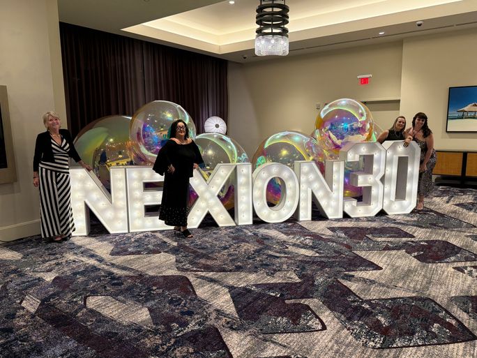 Advisors with the Nexion 30 sign outside the 30th anniversary gala. Advisors with the Nexion 30 sign outside the 30th anniversary gala.
