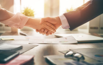 Business handshake in an office