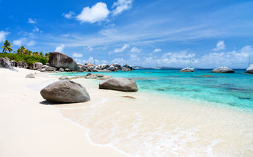 Beautiful tropical beach with white sand, turquoise ocean water and blue sky at Virgin Gorda, British Virgin Islands in Caribbean (Photo via shalamov / iStock / Getty Images Plus)