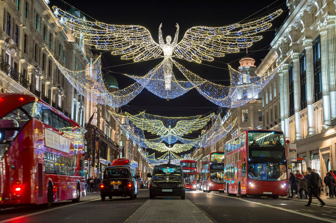 Double-decker buses pass beneath Christmas lights on Regent Street, London, U.K. Double-decker buses pass beneath Christmas lights on Regent Street, London, U.K.