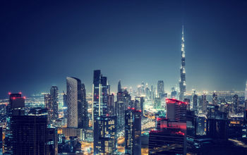 Beautiful Dubai cityscape, bird's eye view on a night urban scene, modern city panoramic landscape, United Arab Emirates (photo via Anna_Om / iStock / Getty Images Plus)