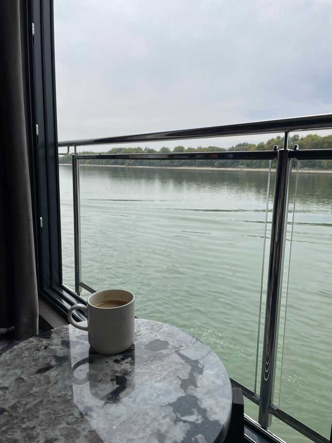 Enjoying a cup of coffee and scenic sailing on Riviera Radiance