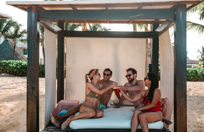 Friends enjoying a Bali Bed at Hard Rock Hotel & Casino Punta Cana Friends enjoying a Bali Bed at Hard Rock Hotel & Casino Punta Cana