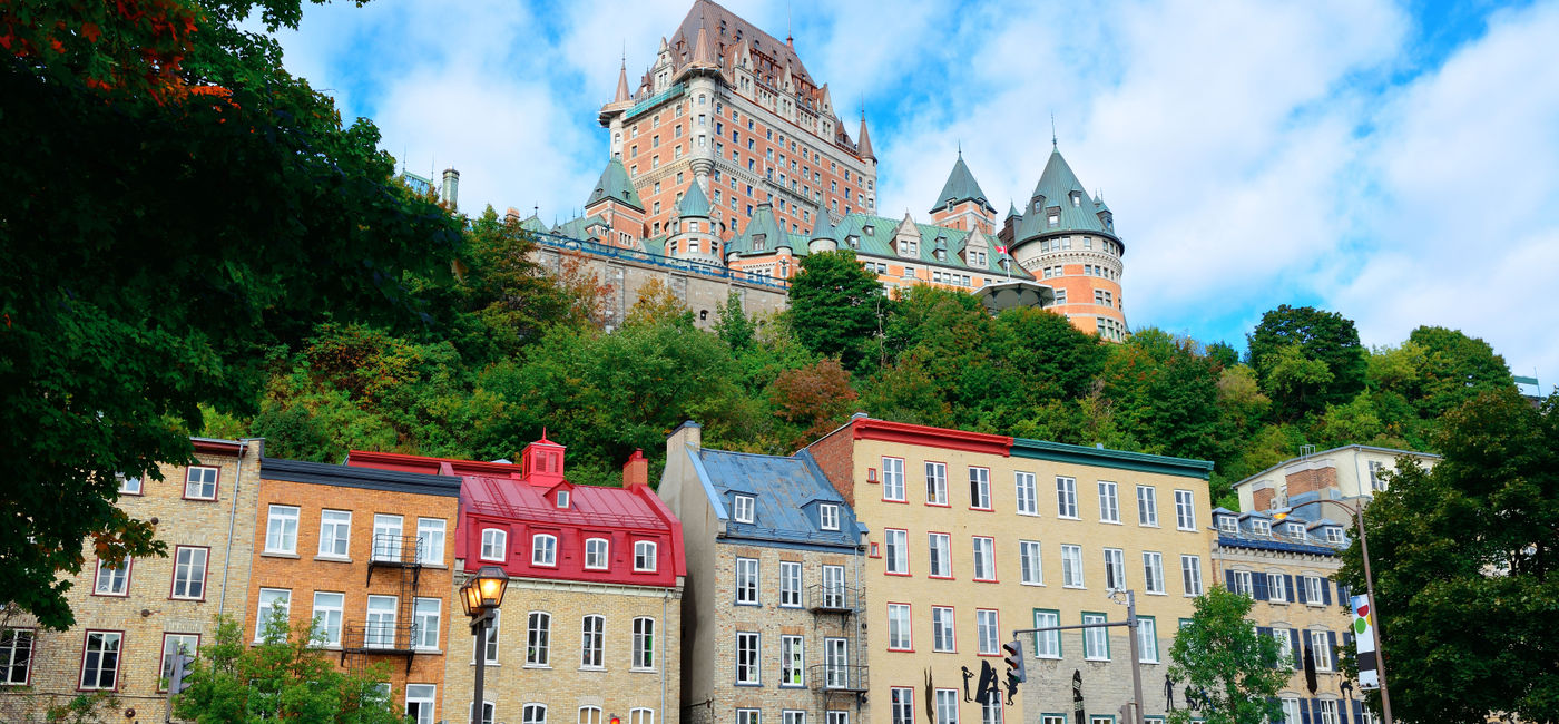 Image: Chateau Frontenac in the day with colorful buildings on street in Quebec City (Photo via rabbit75_ist / iStock / Getty Images Plus)