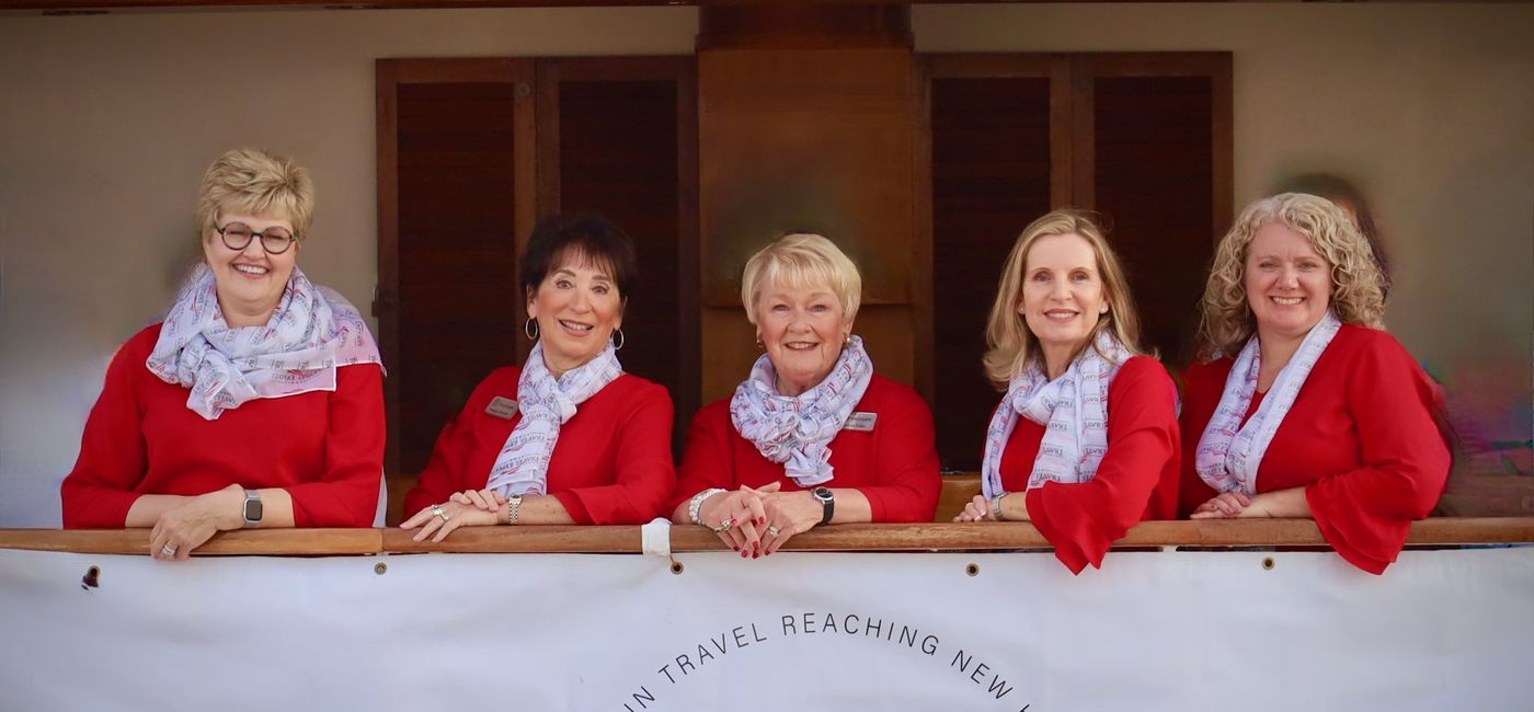 Image: The Travel Experts Executive Team includes (left to right): Michelle Holmes, Executive Support Manager, Susan Ferrell, Owner & President, Sharon Fake, Executive Director, Claire Canady, Director, NC Headquarter Operations, Heather McIntyre, Director Technology & Finance. (Photo Credit: Travel Experts)