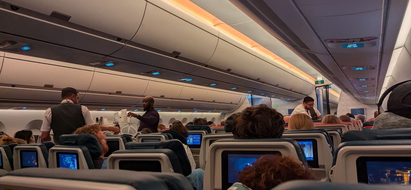 Image: Travelers on a plane (Photo Credit: Eric Bowman)