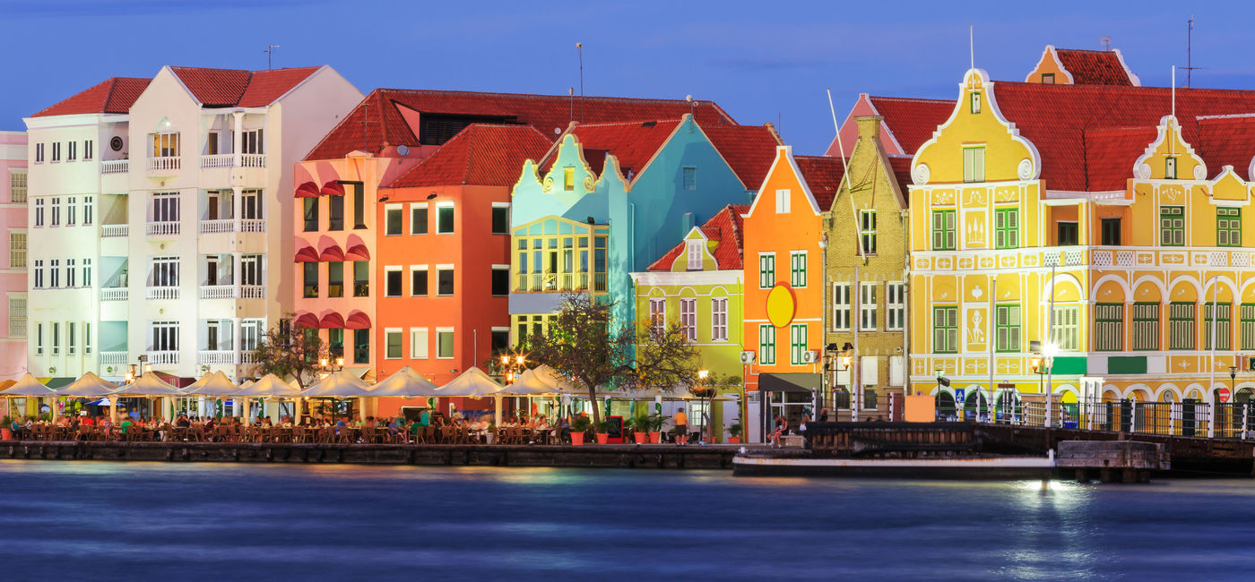 Image: View of downtown Willemstad at twilight. Curacao, Netherlands Antilles (Photo via sorincolac / iStock / Getty Images Plus)
