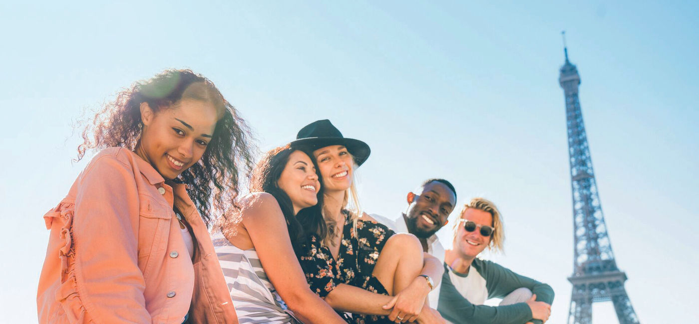 Image: Young Contiki travelers at the Eiffel Tower in Paris (Photo Credit: Contiki)