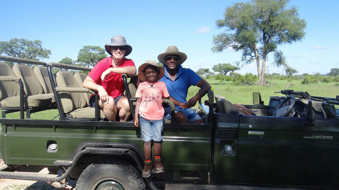 Sherwin Banda, President of African Travel, with his husband and son on safari.