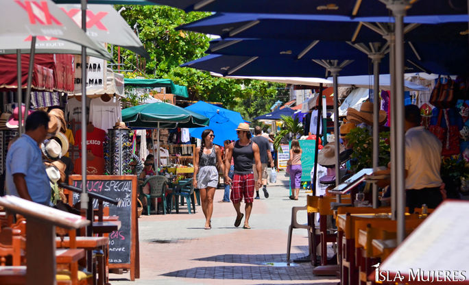 Tourists stroll through a market on Isla Mujeres, Quintana Roo, Mexico. Tourists stroll through a market on Isla Mujeres, Quintana Roo, Mexico.