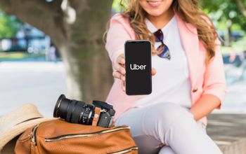 Woman using the Uber app open on her smartphone.